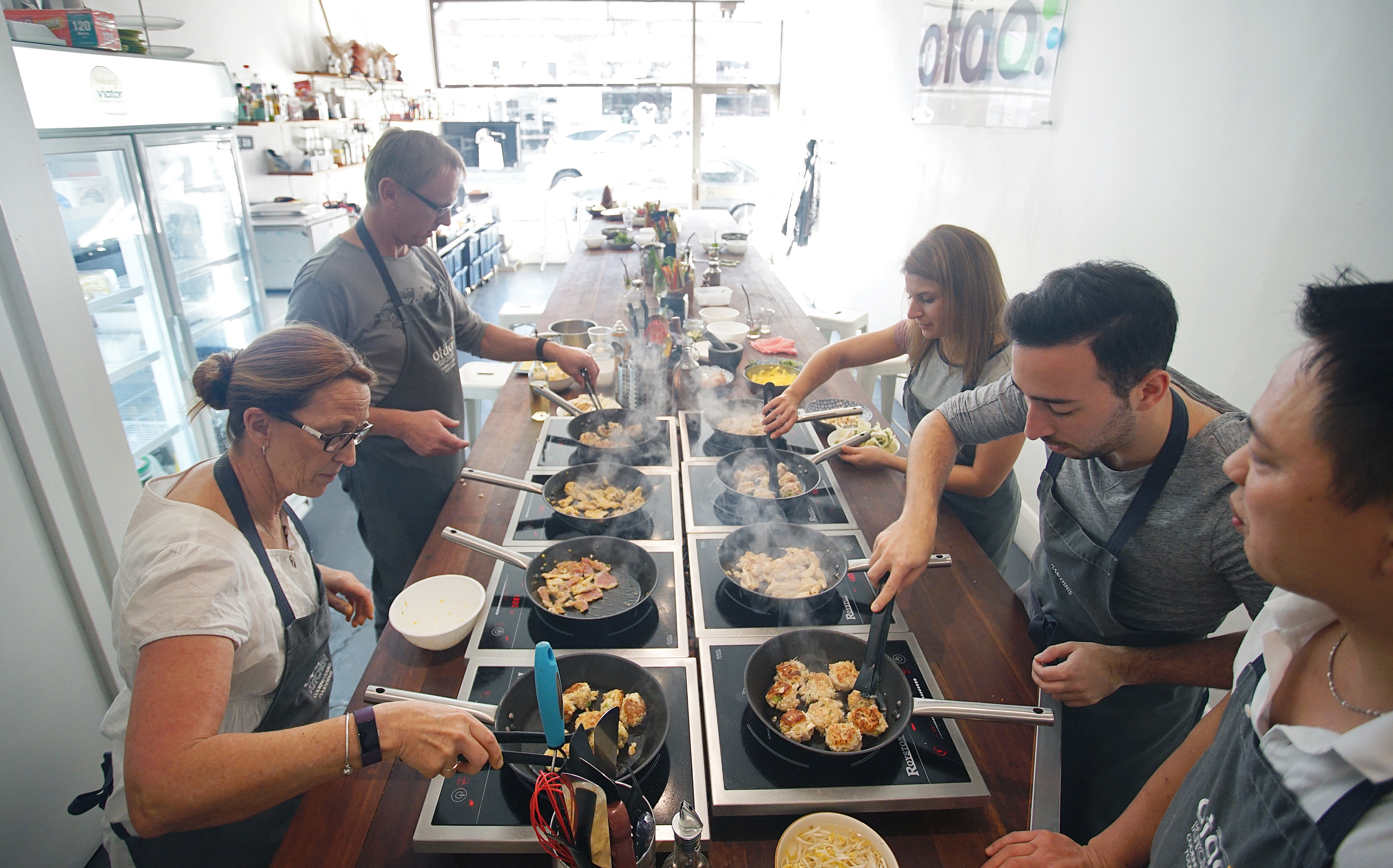 People cooking together at a hands-on class at Otao Kitchen, Abbotsford